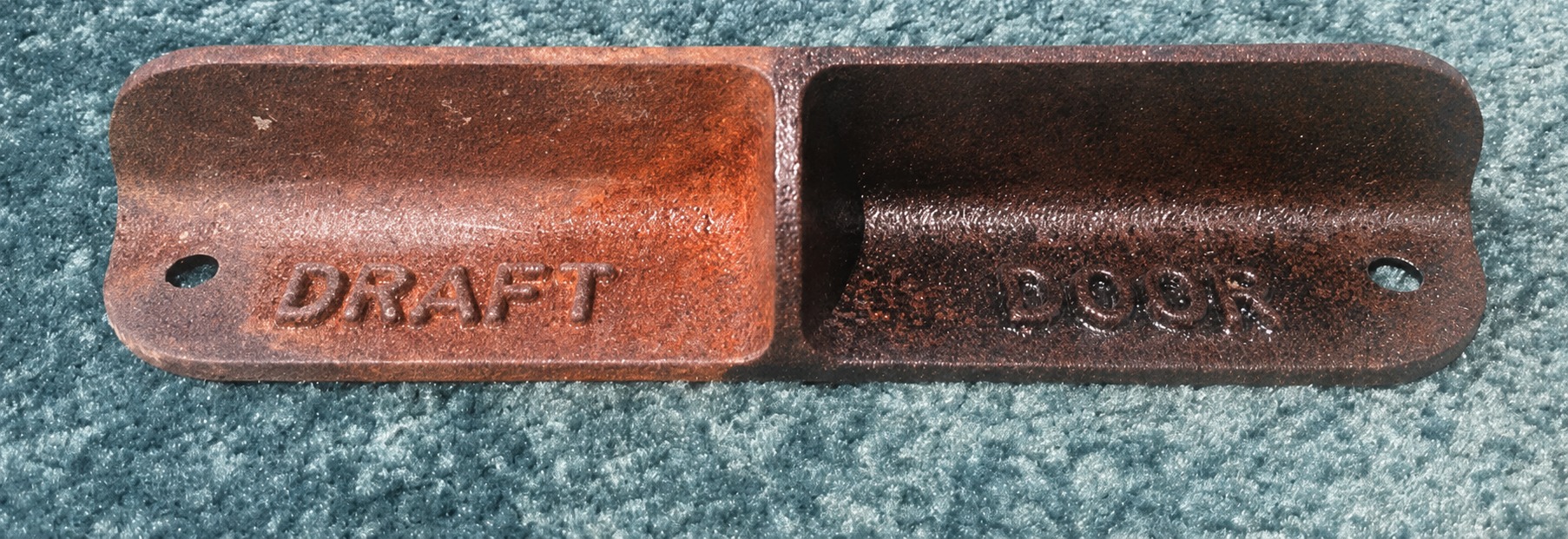 One cast iron plate photographed half rusted and half treated with RustGuard™ Rust Converter