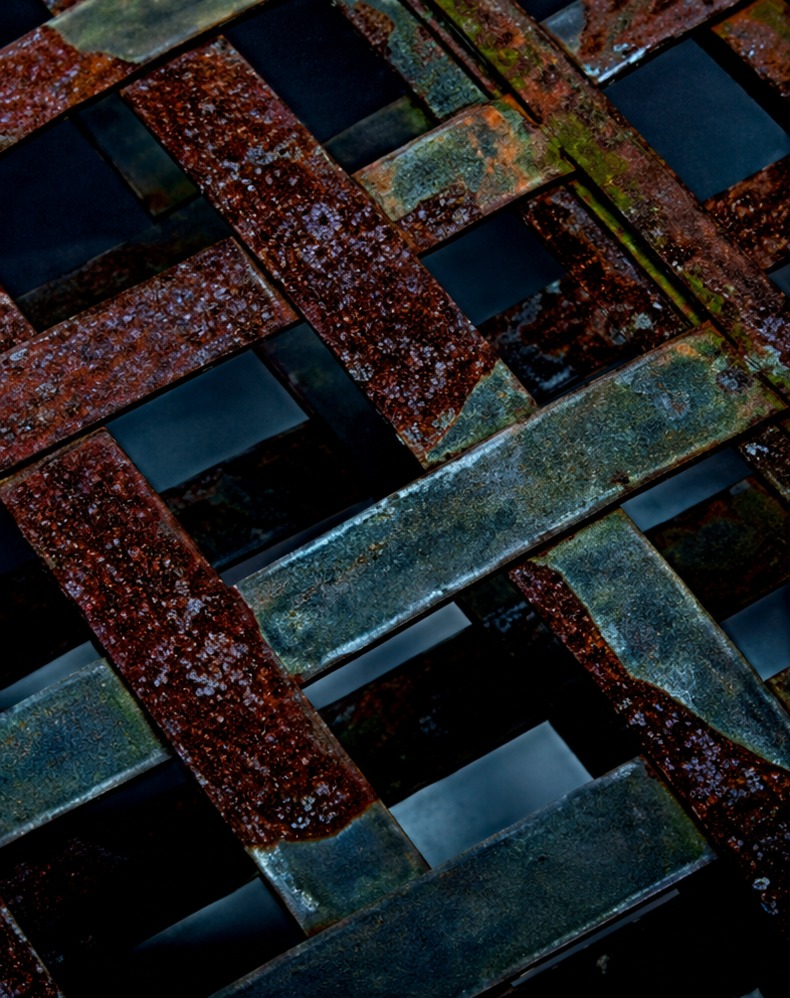 Rusted steel grating covered in orange corrosion before treatment